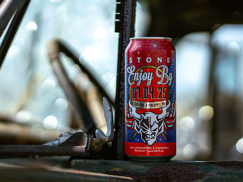 Stone Enjoy By 07.04.25 Tangerine & Pineapple IPA beer can on the window sil of a tractor