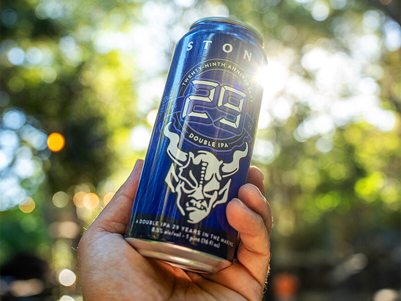 stone 29th anniversary double ipa can in hand